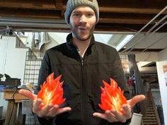 a man holding two different colored lights in his hands