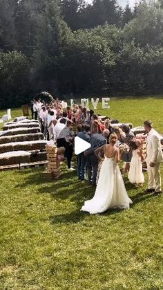 a bride and groom standing in front of an outdoor ceremony