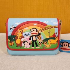 Heading To Planned Pines For A Day Of Fun And Adventure? There’s Nothing But Clear Skies Ahead When You Bring Along This Super Sweet Paul Frank Crossbody Bag! Make This The Perfect Gift For That Special Someone... Or Just Treat Yourself! * * * * Features * * * * * * Height 6.5" * Width 2" * Length 9.5" * Crossbody Strap In Red ... 22" Drop Adjustable And Detachable * Magnetic Snap Closure * Gold Hardware * Faux Leather Exterior With Debossed Accents * Interior Is Red Julius Face Print Fabric * Inside Has 1 Zip Pocket * By Loungefly & Paul Frank * New With Tags Make This Your New Favorite Handbag! Playful Crossbody Shoulder Bag With Mobile Phone Bag, Playful Blue Bag With Adjustable Strap, Playful Crossbody Shoulder Bag For Travel, Playful Crossbody Bag For Daily Use, Playful Multicolor Crossbody Bag, Playful Satchel Shoulder Bag With Adjustable Strap, Playful Multicolor Satchel Shoulder Bag, Playful Multicolor Shoulder Bag With Removable Pouch, Playful Multicolor Shoulder Bag For Travel