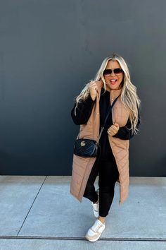 Model wearing a black top and black pants. She also has on a tan puffer vest. Long Puffer Vest, Puffer Vest Outfit, Vest Outfits For Women, Olive Tan, Short Maxi Dress, Vest Outfit, Denim Short Dresses, Vest Blouse, Long Puffer