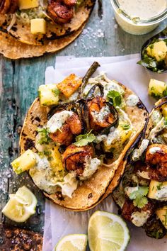 two tacos with shrimp and avocado on them