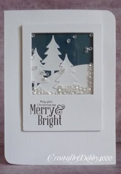 a white frame with christmas trees and pearls