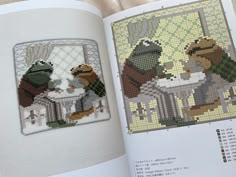 the cross stitch book is open to show an image of two frogs eating at a table