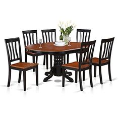 a dining room table with six chairs and a vase on top of the table in front of it