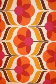 an orange, pink and brown flower pattern on fabric