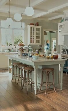 a kitchen island with stools in front of it