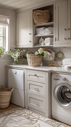 a washer and dryer in a room with lots of cupboards on the wall