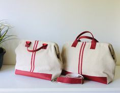 "Beautiful and practical doctor's bag made from a red striped vintage style European grain sack. The fabric is made in Provence - France. 14\" wide ( 35 cm) x 13\" (33 cm) high with lightweight but strong metal frame. Main part of bag is 100% cotton grain sack fabric. Lower portion of bag is red genuine leather. Handles are red genuine leather 6\" (15 cm) drop. The bag comes with removable adjustable leather red messenger cross body strap. Two slide pockets inside. One is designed to hold your m Retro Red Satchel For Everyday Use, Everyday Red Canvas Satchel, Red Rectangular Bag With Canvas Lining, Red Satchel Canvas Bag, Red Travel Bags With Rolled Handles, Retro Red Cotton Bag, Red Canvas Bag With Leather Handles, Grain Sack Fabric, Unique Purses