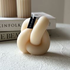 a small white object sitting on top of a table next to two bookends