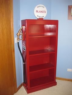 a red book shelf with a gas pump on top