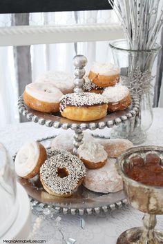 three tiered trays filled with donuts on top of a table