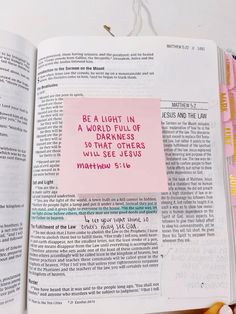 an open bible with sticky notes attached to it