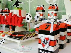 the table is set up for a soccer themed birthday party with paper decorations and cupcakes