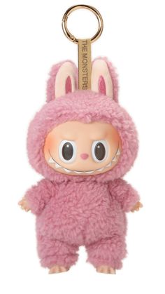 a pink stuffed animal keychain with eyes and ears