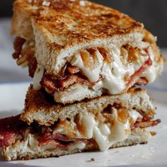 a grilled cheese sandwich with caramelized onions and bacon is on a plate