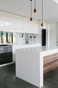 a kitchen with white cabinets and an island in the middle is featured on instagram