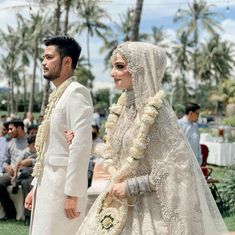 a bride and groom walking down the aisle