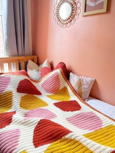 a crocheted blanket sitting on top of a bed