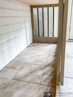 an empty room with white walls and tile flooring is pictured in this image from the outside