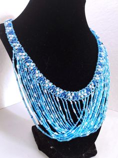 A handmade glass beaded necklace that is perfect for any occasion: parties, holidays, birthdays, anniversaries. All products are hand-crafted by my mother. Dimensions: - Length: 28.5 cm - Width: 22.0 cm - Height: 2.0 cm Lightweight, high quality with a beaded hook as a clasp.  Acrylic Pearls: 8 mm. Will respond to concerns and suggestions promptly. Shipping costs: Free Domestic Shipping. All orders are sent by air-mail with tracking number. Time of delivery: Estimated 1-3 days for domestic shipping; international make take 7-14 days. Feel free to check out our other similar products! https://noorsjewelers.etsy.com Adjustable Beaded Bridal Necklace For Parties, Turquoise Round Beads Necklace For Party, Turquoise Necklaces With Round Beads For Party, Turquoise Faceted Beads Necklaces For Party, Blue Beaded Necklace For Gift, Party Turquoise Beaded Necklaces With Faceted Beads, Party Turquoise Faceted Beaded Necklaces, Turquoise Bib Necklace With Round Beads For Gifts, Handmade Turquoise Necklace For Party