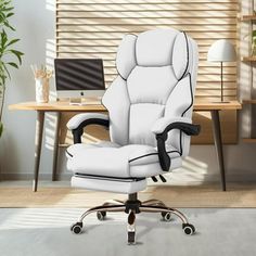 a white office chair sitting in front of a desk with a laptop computer on it