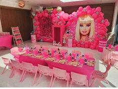 a barbie birthday party with pink decorations and balloons