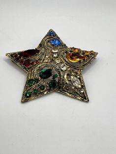 "Nice gold tone metal star with red ,blue ,green, yellow and clear glass rhinestones. LA ROCO star is from 1950-1960's In good  pre-owned vintage condition Measures :2 3/4\" in diameter Not signed Please note that due to lighting effects, monitor's brightness, contrast and other settings, there might be some slight differences in the color tone/shade of the website's photo and the actual item. Item photos are enlarged to show details- please note actual sizes. Please ask any questions. Please se Retro Rhinestone Brooches For Gifts, Vintage Star-shaped Jewelry For Party, Vintage Star-shaped Party Jewelry, Gold Star Brooches As Gift, Star Brooch, Metal Star, Metal Stars, White Peonies, Brooch Vintage