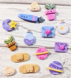 some cute little magnets on a white wooden table with stars, moon and other things