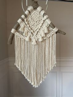 a macrame hanging from a hook on a wall