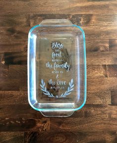 a glass dish with a quote on it sitting on top of a wooden table next to a wall