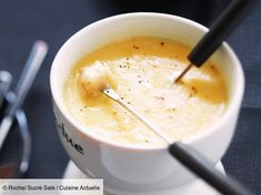 a white bowl filled with soup on top of a table