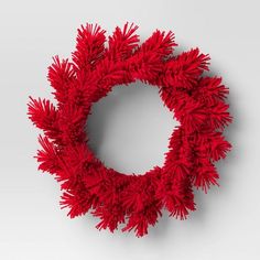 a red wreath is hanging on the wall