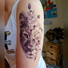 a woman with a tiger and flowers tattoo on her arm