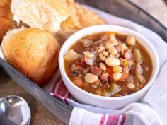 a bowl of soup with bread on the side