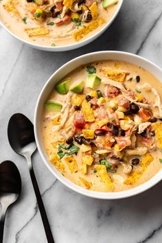 two bowls filled with soup on top of a table