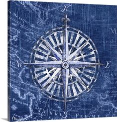 a compass on blue paper with writing in the background