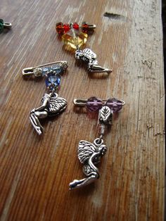 four charms sitting on top of a wooden table