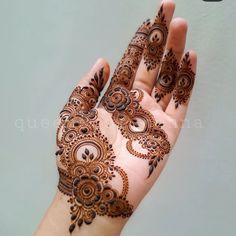 the hand is decorated with henna on it