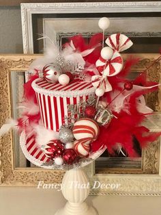 a red and white striped cake decorated with candy canes, candies and ornaments