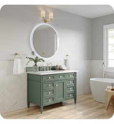 a bathroom with a sink, mirror and bathtub in the middle of the room