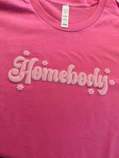 Stay comfortable and stylish in our Homebody T-shirt with puff letters design. Made with eco-friendly materials, this unisex shirt is soft and cozy, perfect for lazy days at home or a casual outing. Embrace your inner homebody with this must-have wardrobe staple! How to Order: 1- Pick size and color shirt 2- Add to cart and go to cart 3-in the instructional box enter: puff color 4-Check out Letters Design, Box Tops, Lazy Days, Color Shirt, Pink Tshirt, Pink Sweatshirt, Love Notes, Custom Bags, Lettering Design