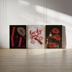 three canvases with lipstick on them sitting in front of a white wall and wooden floor