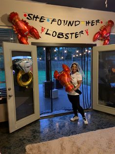 a woman standing in front of a door with balloons on her head and the words she found her lobster