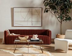 a living room with a couch, chair and coffee table in front of a painting