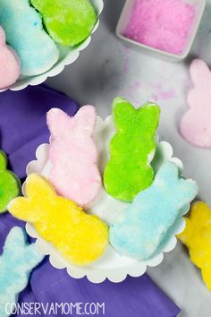 there are some colorful treats in bowls on the table