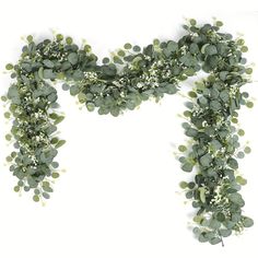 an arrangement of green leaves and flowers on a white background