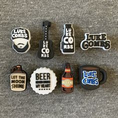 six beer bottle magnets are arranged on the floor, including one with a guitar