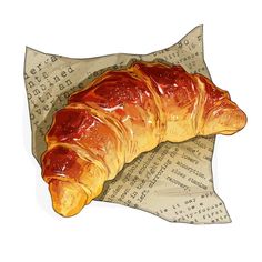 a croissant sitting on top of an old sheet of paper