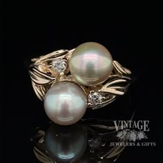 Exquisite silver tone pearls in a 14 karat yellow gold bypass style ring. Each pearl measures approximately 6.5 mm in diameter. The pearls are well matched, with light blemish, slight orient, and good symmetry. They are 1/2 drilled and set on a glue post. In addition to the pearls, the ring features a small round brilliant cut diamond on each side of the bypass. The I1 clarity diamonds have a total weight of .05 carats. They are set in 3 prong heads set as part of the casting. The ring has leaf Unique Gold Pearl Ring In Luxury Range, Luxury Gold Open Pearl Ring, Luxury Romantic Pearl Ring, Luxury Classic Pearl Ring With Polished Finish, Luxury Unique Pearl Ring As Gift, Luxury Engagement Pearl Ring With Pave Setting, Luxury Pearl Ring With Pearl Charm, Luxury Bezel Set Pearl Ring, Luxury Antique Pearl Ring With Diamond