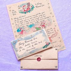 two envelopes sitting on top of each other next to an envelope with a handwritten message